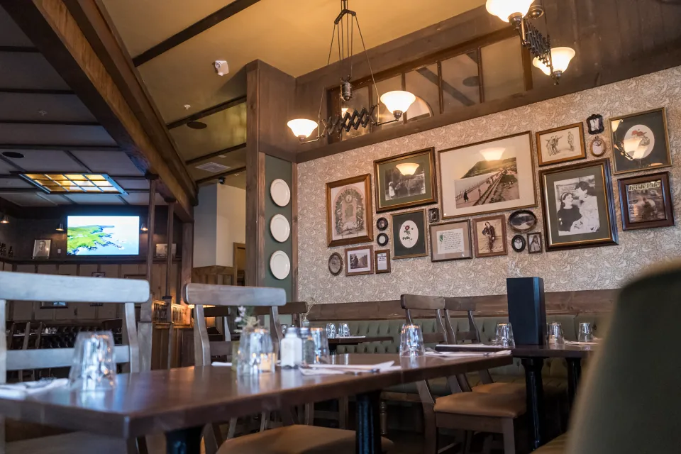 Delany’s dining room with framed photographs and timber furnishings